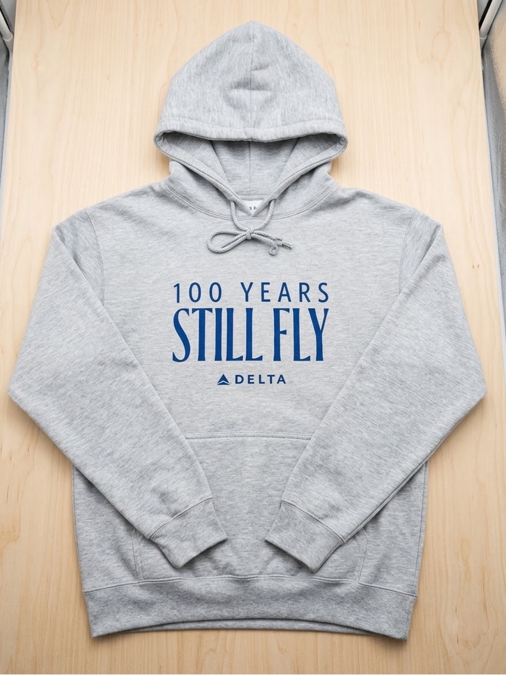 Delta Gray Centennial Unisex Hoodie with Blue '100 Years Still Fly' Logo